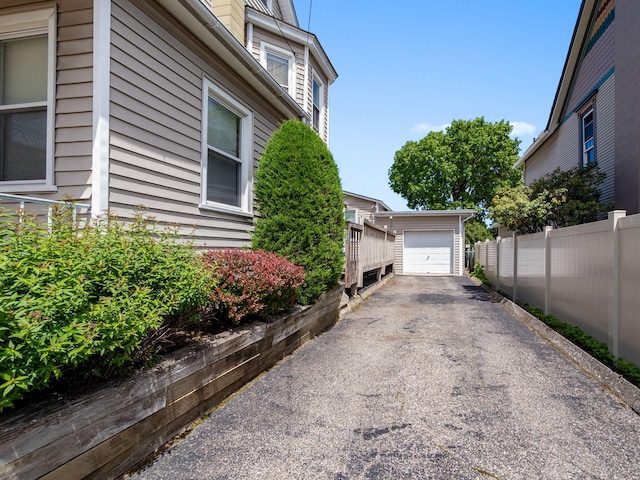 210 N Schanck Ave, Pen Argyl, PA 18072 - view of home's exterior with an outbuilding, asphalt driveway, and a detached garage