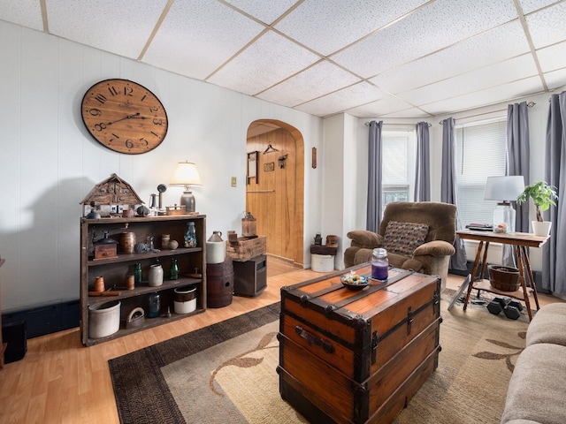 210 N Schanck Ave, Pen Argyl, PA 18072 - living room featuring a drop ceiling, arched walkways, wood finished floors, and wooden walls