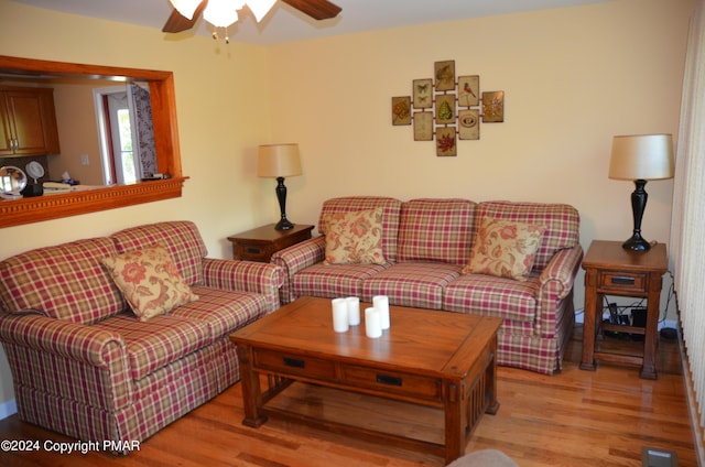 living area featuring a ceiling fan, visible vents, and light wood-type flooring