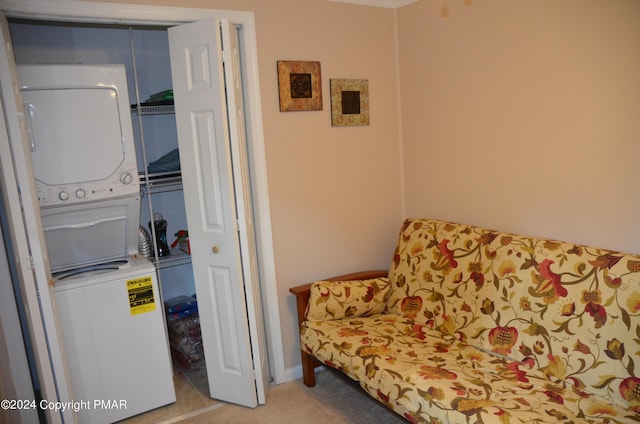 living area featuring stacked washing maching and dryer