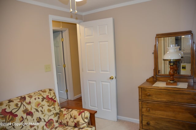 sitting room with baseboards, carpet floors, and ornamental molding