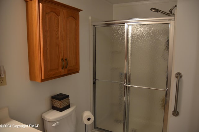 full bath featuring toilet and a shower stall