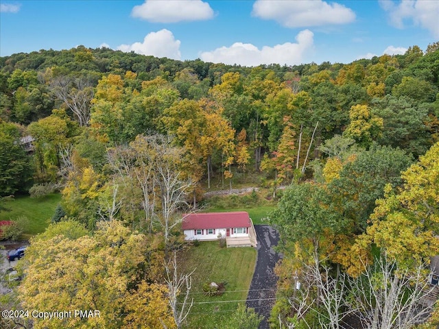 birds eye view of property with a view of trees