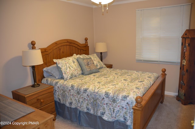 bedroom with light carpet, crown molding, and baseboards