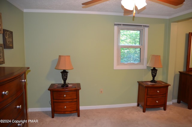 bedroom featuring baseboards, light colored carpet, crown molding, and a textured ceiling