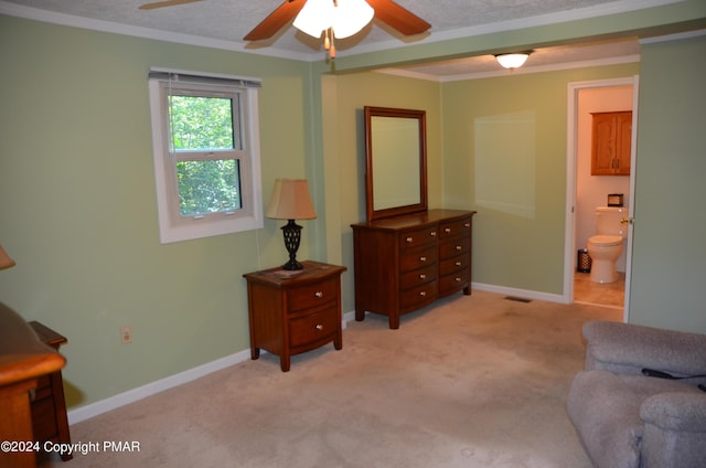 living area with light carpet, ornamental molding, a textured ceiling, baseboards, and ceiling fan