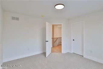 unfurnished bedroom featuring baseboards and visible vents