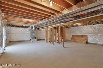 unfinished basement featuring heating unit