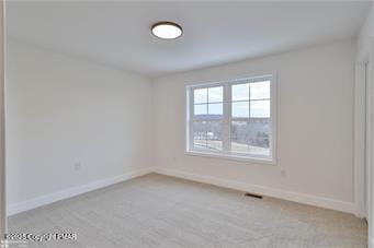 carpeted empty room with baseboards