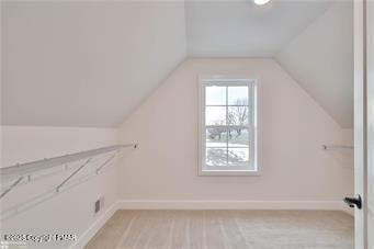 bonus room featuring vaulted ceiling and baseboards