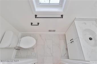 bathroom featuring toilet, visible vents, and vanity