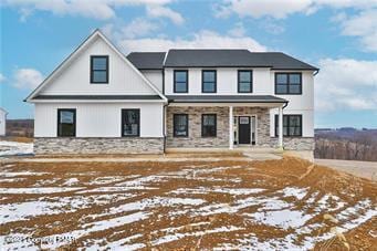 modern inspired farmhouse featuring stone siding