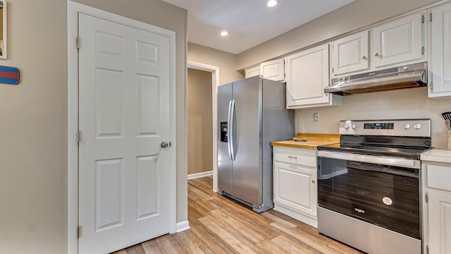 235 White Pine Ln, Pocono Lake, PA 18347 - kitchen with stainless steel appliances, under cabinet range hood, light countertops, white cabinets, and light wood-style flooring