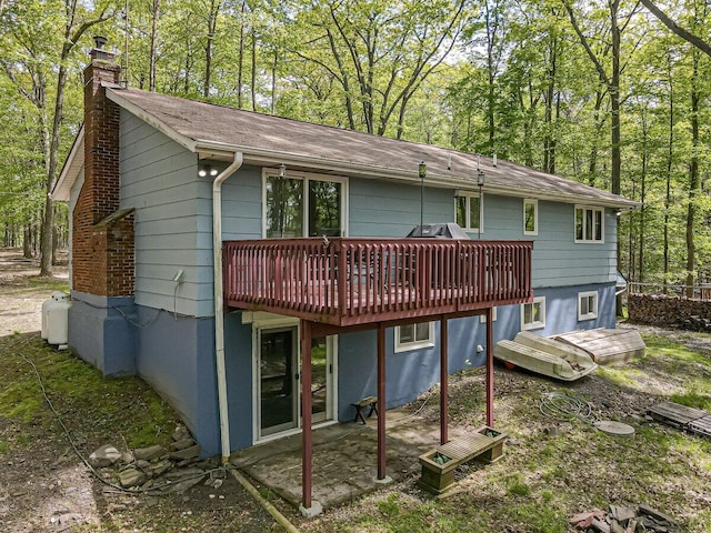 235 White Pine Ln, Pocono Lake, PA 18347 - back of property with a chimney, a deck, and roof with shingles