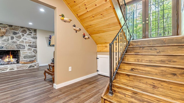 235 White Pine Ln, Pocono Lake, PA 18347 - staircase with baseboards, wood finished floors, a fireplace, and vaulted ceiling