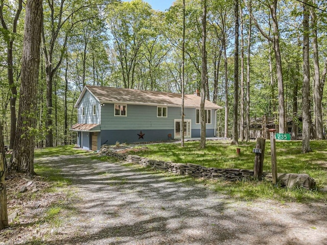 235 White Pine Ln, Pocono Lake, PA 18347 - view of front facade with a garage, gravel driveway, and a chimney