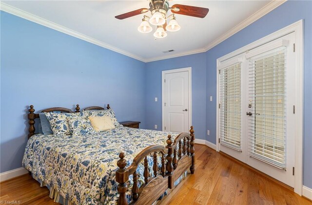 bedroom featuring ceiling fan, crown molding, light wood-type flooring, and access to exterior