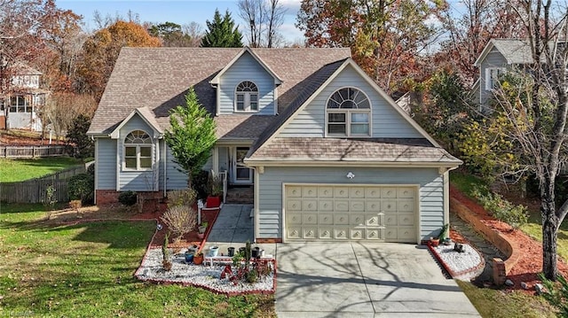 view of front of property featuring a garage, fence, driveway, roof with shingles, and a front lawn