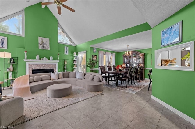 living room with high vaulted ceiling, plenty of natural light, a fireplace, and baseboards