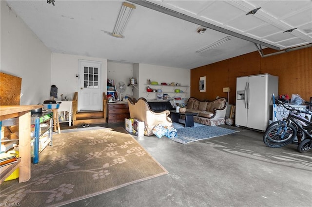 garage with white refrigerator with ice dispenser