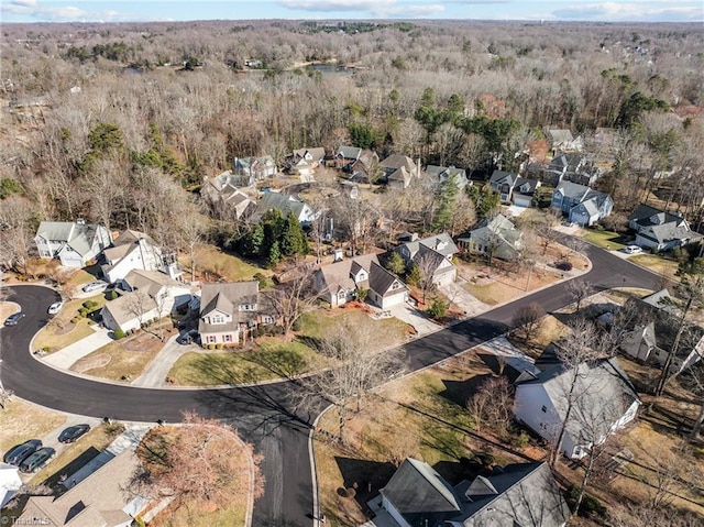 drone / aerial view featuring a forest view and a residential view