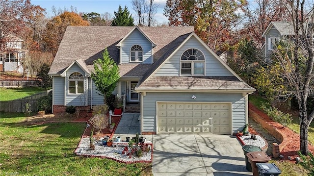 view of front of property with a garage, fence, driveway, roof with shingles, and a front yard