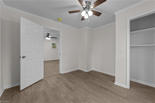 unfurnished bedroom featuring crown molding, ceiling fan, light hardwood / wood-style floors, and a closet