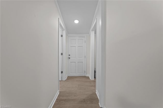 corridor with light hardwood / wood-style floors