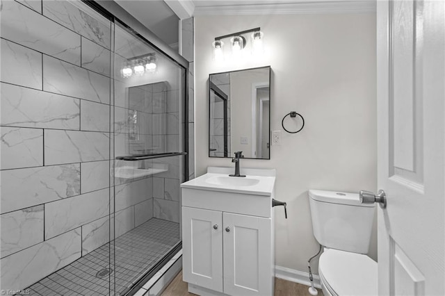 bathroom featuring ornamental molding, toilet, an enclosed shower, and vanity