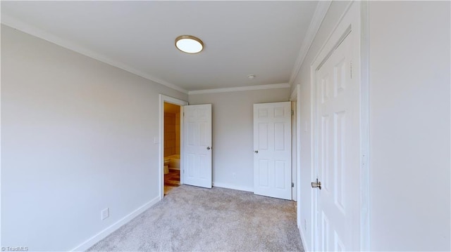 unfurnished bedroom with ornamental molding and light colored carpet