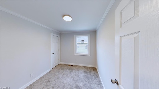 unfurnished room featuring crown molding and light colored carpet