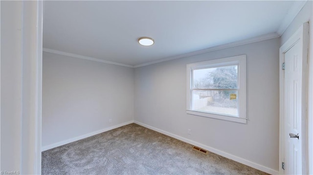 carpeted empty room featuring crown molding