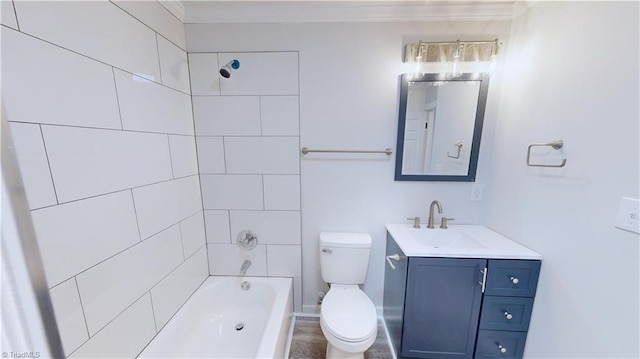 full bathroom with vanity, tiled shower / bath, and toilet