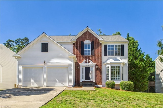 4029 Tutbury Dr, Jamestown, NC 27282 - view of front of home featuring concrete driveway, a front lawn, and a garage