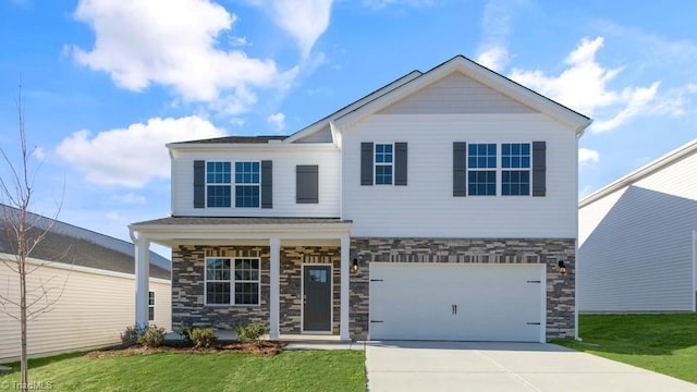 view of front of home with a front lawn, concrete driveway, a garage, stone siding, and covered porch