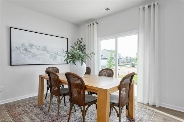 dining area with wood finished floors and baseboards