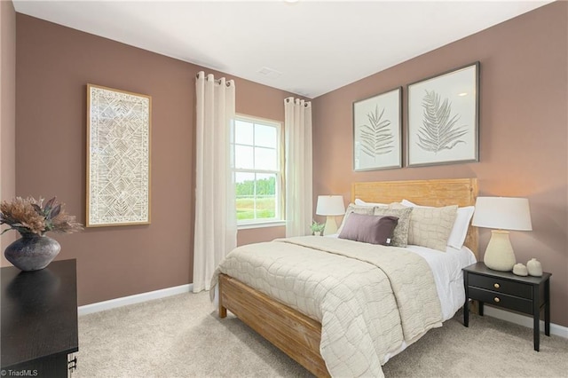 bedroom featuring carpet and baseboards
