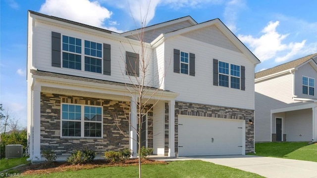 view of front of house with stone siding, a garage, a front lawn, and driveway