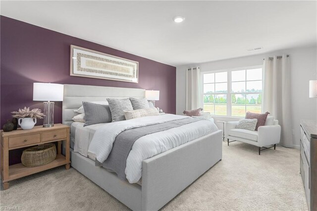 bedroom featuring light colored carpet