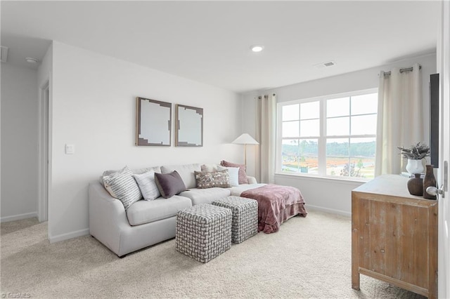 carpeted living area featuring baseboards and recessed lighting