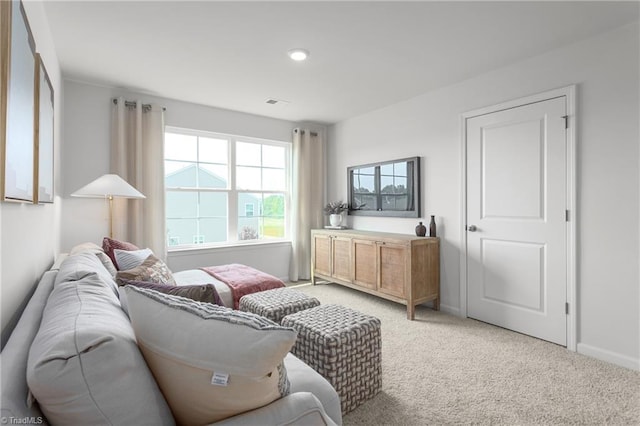 living area with light carpet, baseboards, and recessed lighting
