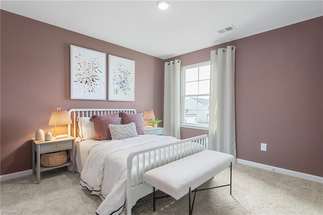 bedroom with light carpet and baseboards
