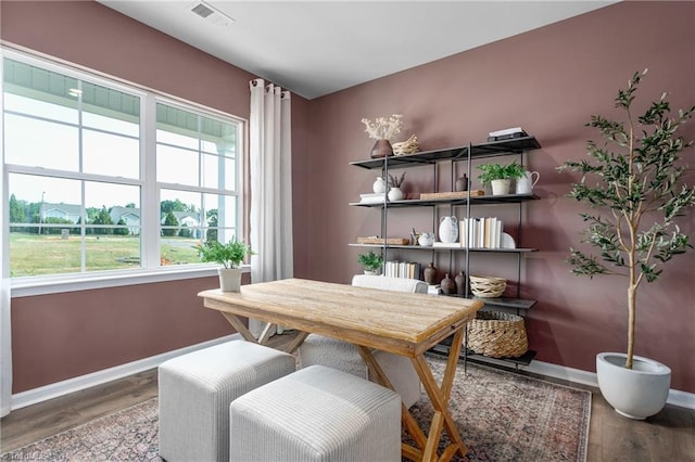 dining area with baseboards and wood finished floors