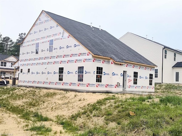 exterior space with a shingled roof