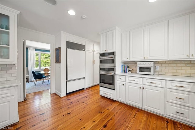 948 Kenleigh Cir, Winston-Salem, NC 27106 - kitchen featuring paneled built in refrigerator, stainless steel double oven, ornamental molding, backsplash, and white cabinetry