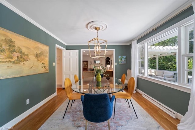 948 Kenleigh Cir, Winston-Salem, NC 27106 - dining space with a baseboard heating unit, wood finished floors, and crown molding