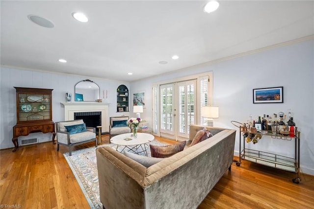 948 Kenleigh Cir, Winston-Salem, NC 27106 - living room featuring ornamental molding, wood finished floors, a fireplace, recessed lighting, and french doors