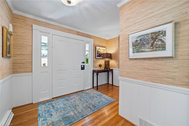 948 Kenleigh Cir, Winston-Salem, NC 27106 - entryway with a baseboard heating unit, a wainscoted wall, crown molding, and wood finished floors