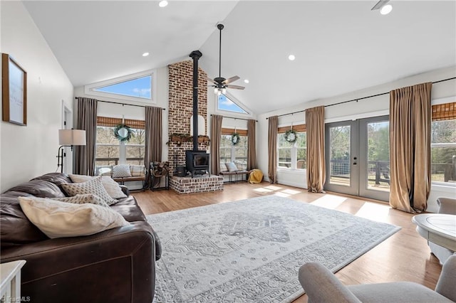 4420 Bunton Swaim Rd, Liberty, NC 27298 - living room featuring ceiling fan, high vaulted ceiling, wood finished floors, and a wood stove