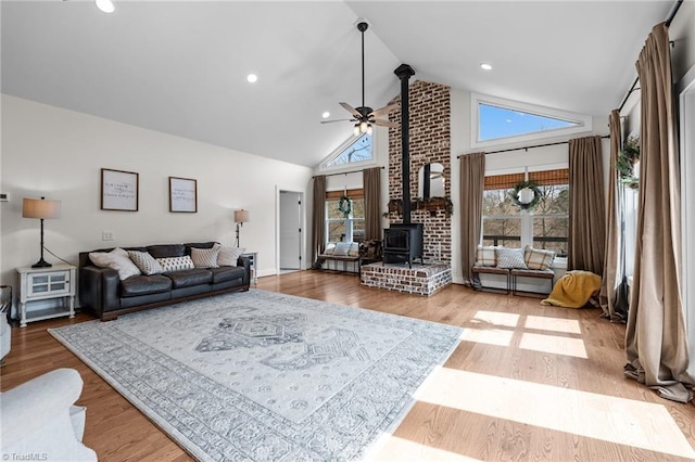 4420 Bunton Swaim Rd, Liberty, NC 27298 - living room featuring ceiling fan, high vaulted ceiling, wood finished floors, and a wood stove